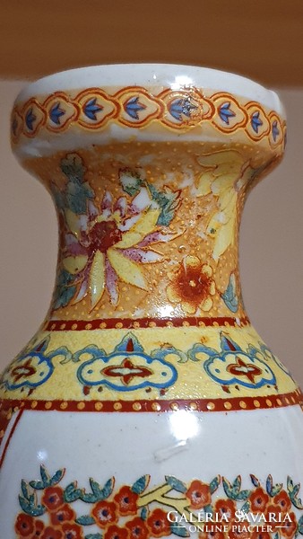 A small vase with an oriental motif.