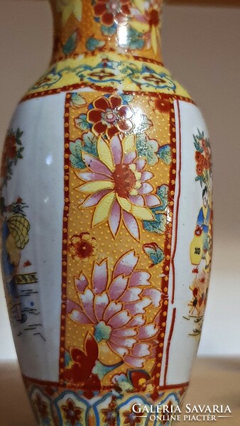 A small vase with an oriental motif.