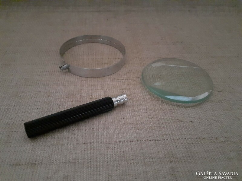 Large magnifying glass with old metal housing and screw handle