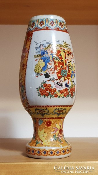 A small vase with an oriental motif.