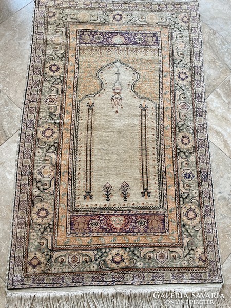 Antique silk carpet in gold color