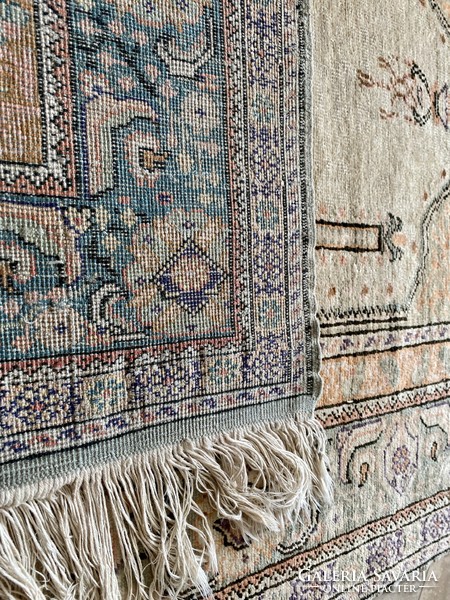 Antique silk carpet in gold color