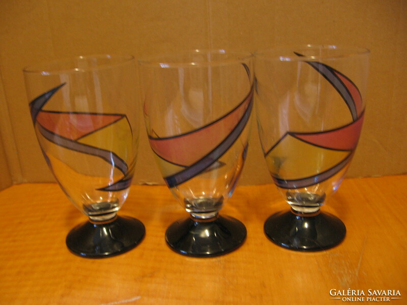 3 colorfully painted pedestal vases with soft drinks and beer glasses in one.