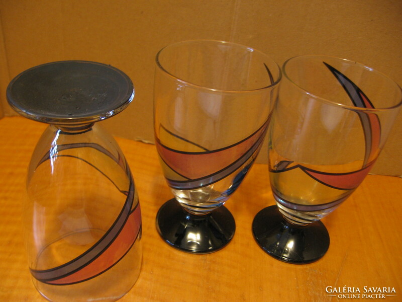 3 colorfully painted pedestal vases with soft drinks and beer glasses in one.