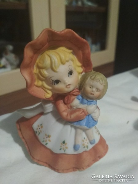 Charming biscuit girl with doll