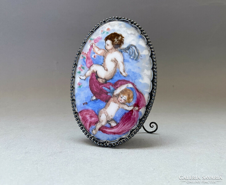 Old, putto, painted porcelain table decoration in a silver frame.