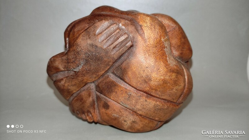 Wooden sculpture human representation crying yogi