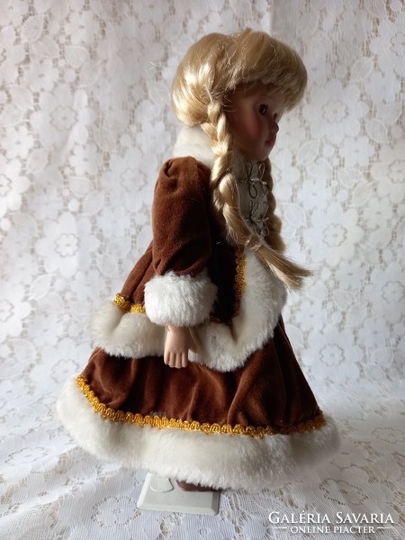 Doll with porcelain head in winter velvet outfit