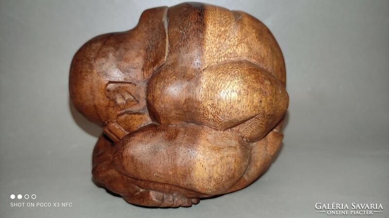 Wooden sculpture human representation crying yogi