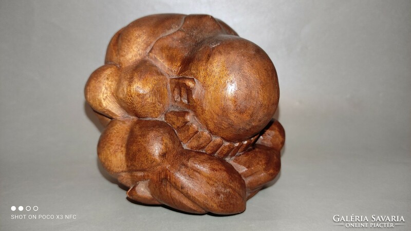 Wooden sculpture human representation crying yogi