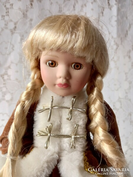 Doll with porcelain head in winter velvet outfit