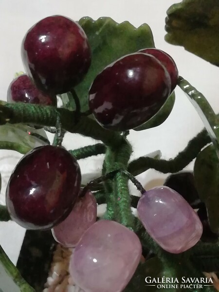 Mineral cluster of grapes in a ceramic bowl.