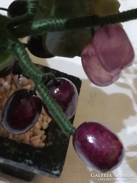 Mineral cluster of grapes in a ceramic bowl.