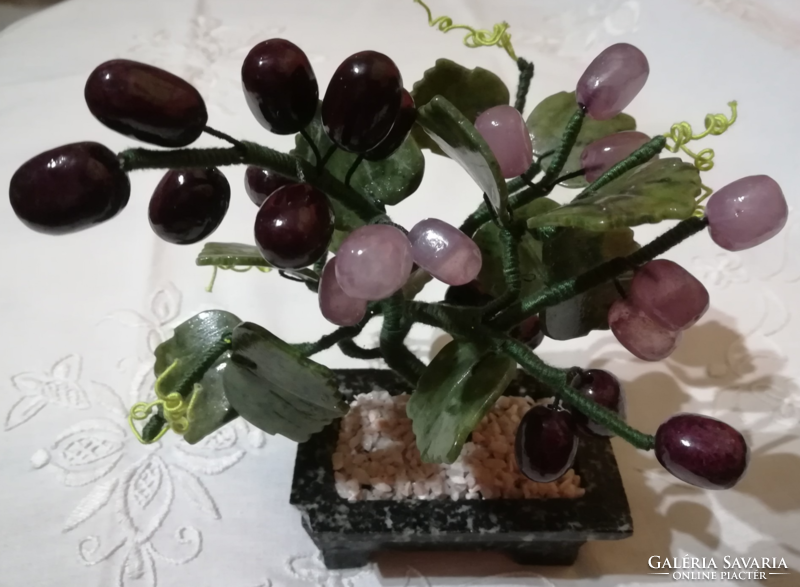 Mineral cluster of grapes in a ceramic bowl.