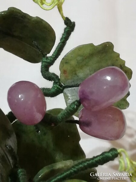 Mineral cluster of grapes in a ceramic bowl.