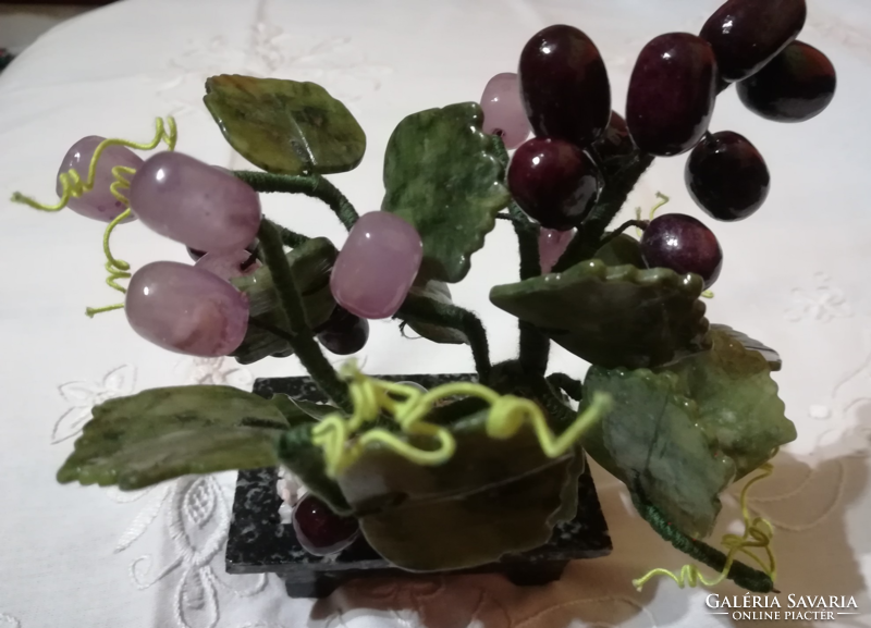 Mineral cluster of grapes in a ceramic bowl.