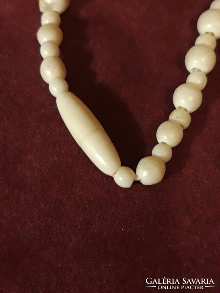 Carved bone necklace with ring decoration - 60 cm