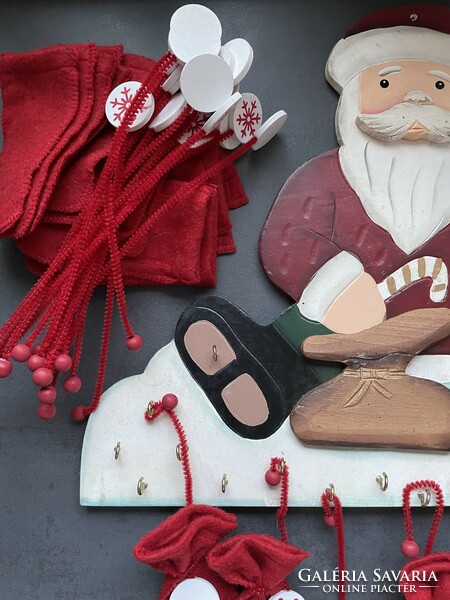 Santa's advent calendar made of wood with felt bags