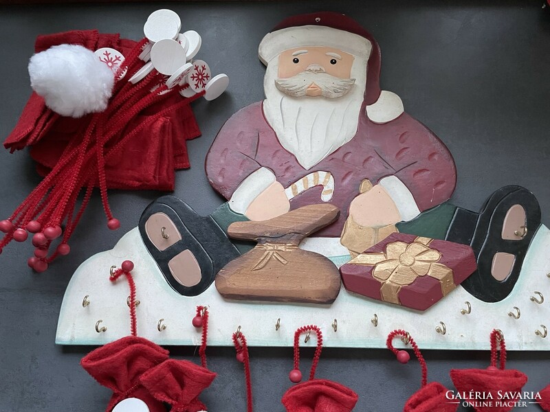 Santa's advent calendar made of wood with felt bags