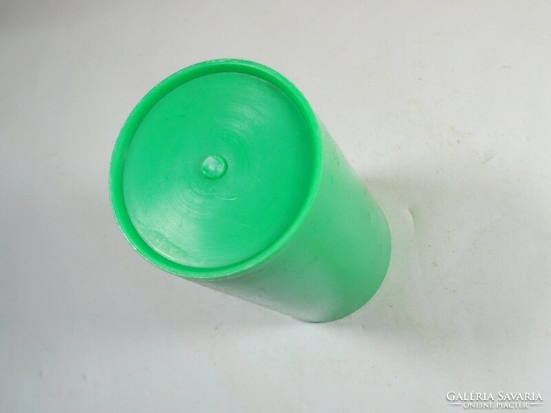 Retro old green plastic toothbrush cup from the 1970s