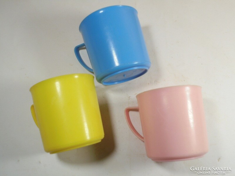 Retro old colorful plastic toothbrush children's cup DDR from the East German 1970s