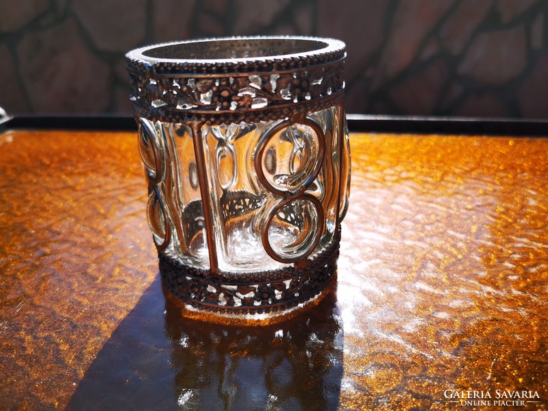 Glass candle holder in a metal frame