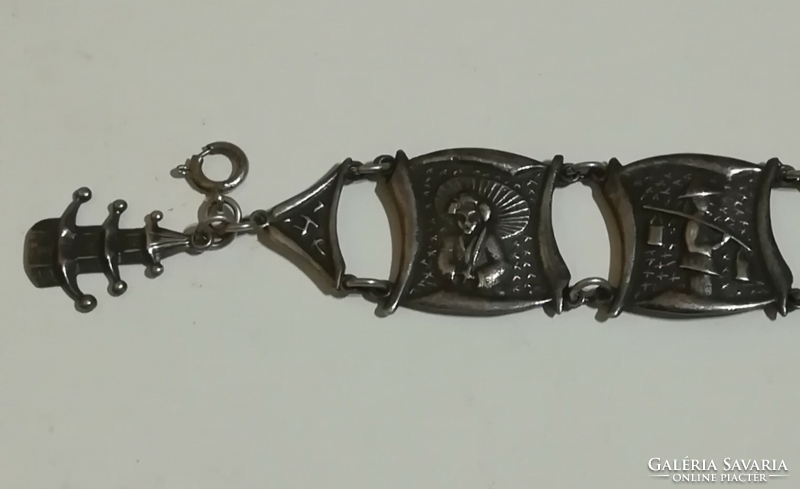 Silver-plated metal bracelet with an oriental motif.