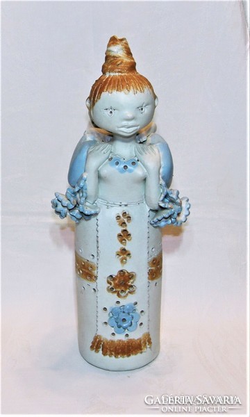 Eva, an early blacksmith - a mother with a child on her back - is a large ceramic figure
