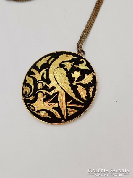 Toledo bird pendant on a chain