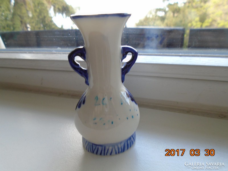 Small vase with children's figures painted in cobalt blue under the glaze