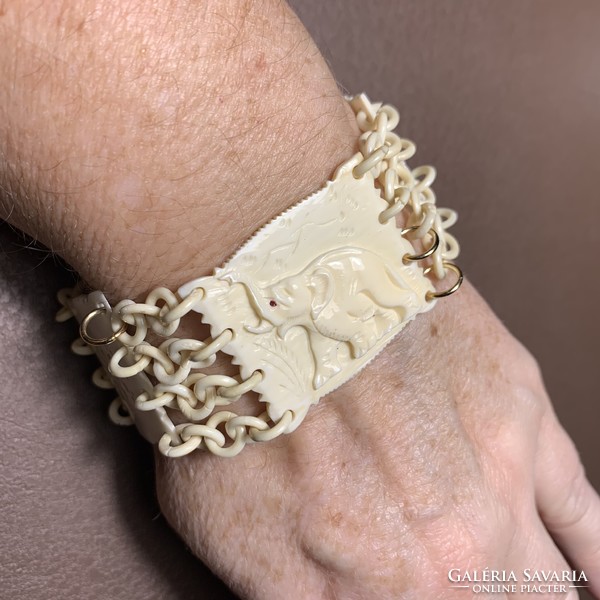 Old elephant patterned bone bracelet elaborately restored with gilded eyes, elephant bangle