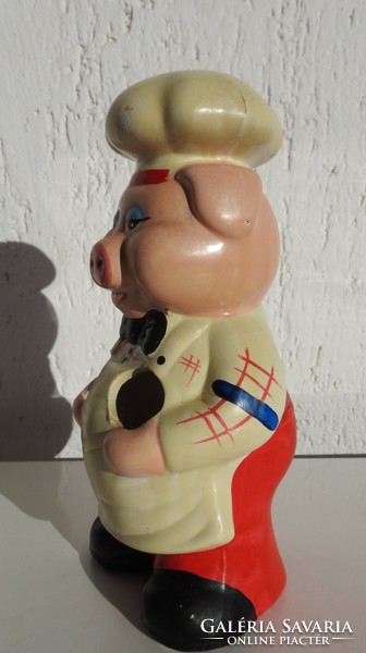 Vintage wooden kitchen spoon holding pig figurine - photo in the kitchen