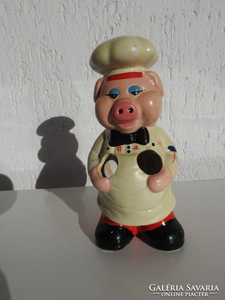 Vintage wooden kitchen spoon holding pig figurine - photo in the kitchen