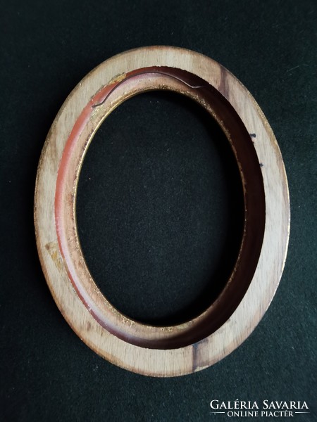 Old oval, gilded wooden picture frame