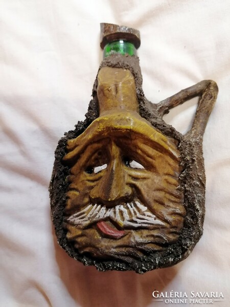 Glass bottle with an old man's face