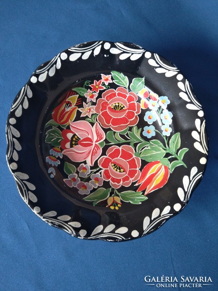 Decorative plate painted on a black background
