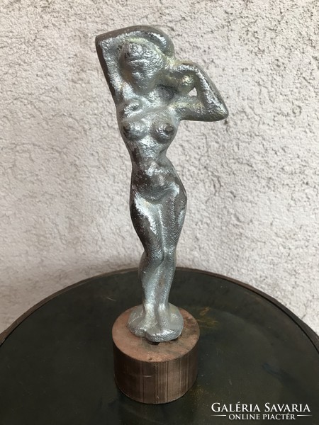 Cast iron female nude sculpture on a copper pedestal