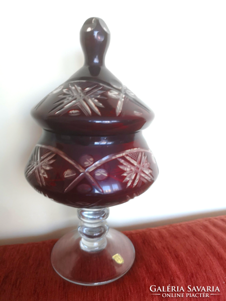 A large burgundy crystal stand with a bonbonier lid