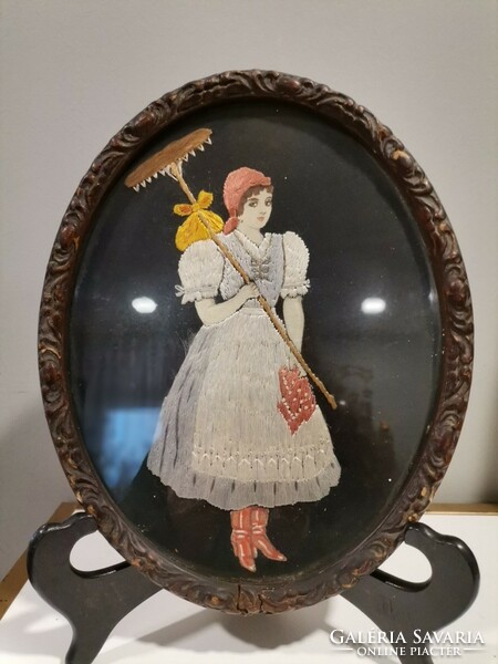 Antique embroidered picture in a carved oval frame