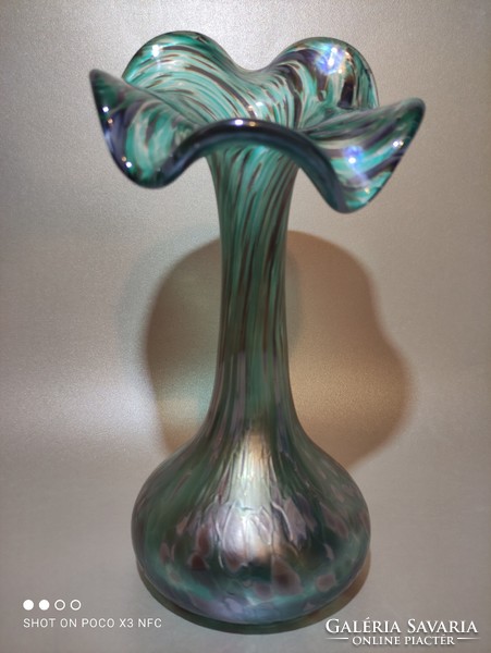 The iridescent frilled glass vase is gorgeous green