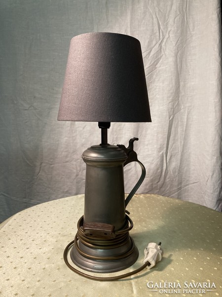A table lamp made of a tin beer mug.