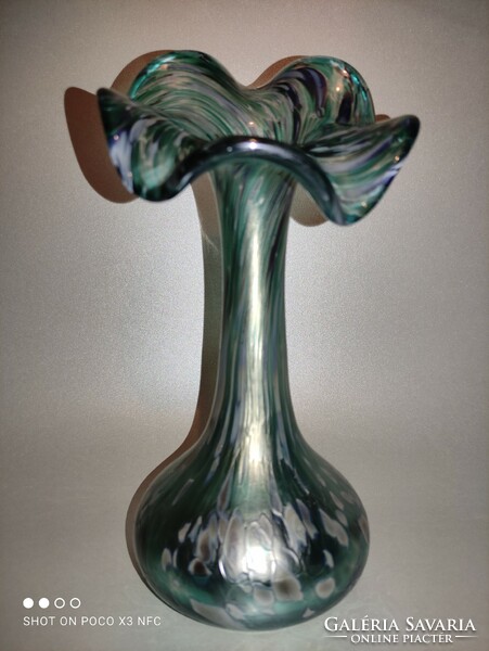 The iridescent frilled glass vase is gorgeous green