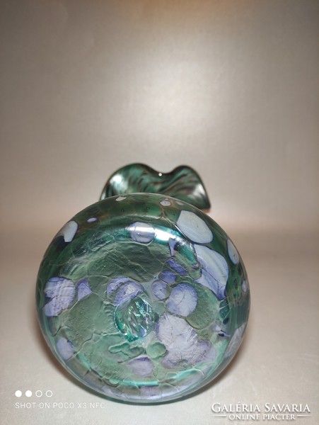 The iridescent frilled glass vase is gorgeous green