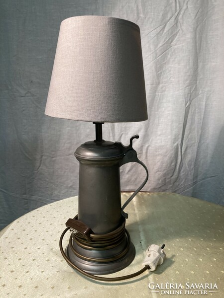 A table lamp made of a tin beer mug.