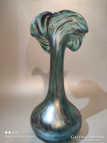 The iridescent frilled glass vase is gorgeous green