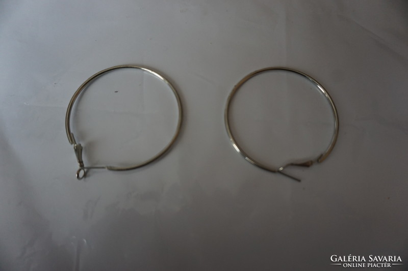 Stainless, smooth, polished metal alloy plug-in hoop earrings for sale.
