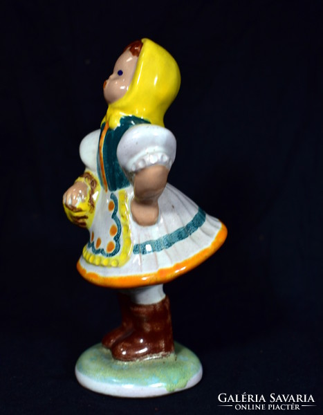 Hand-painted ceramic figurine of a lady in a glazed pein