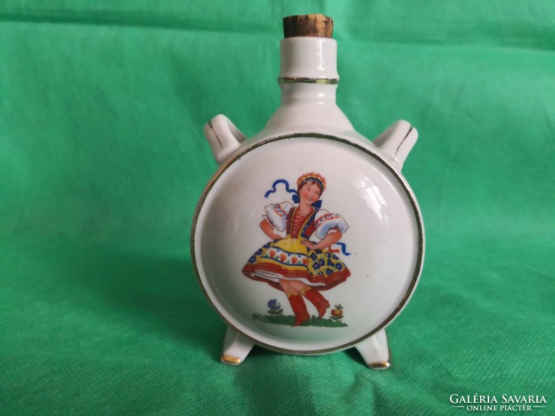 Antique drasche water bottle, a shepherd playing the flute with his dog, a dancing woman on the other side
