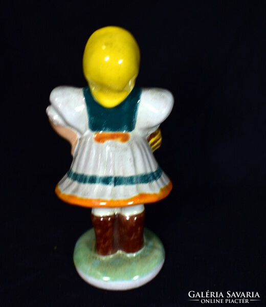 Hand-painted ceramic figurine of a lady in a glazed pein