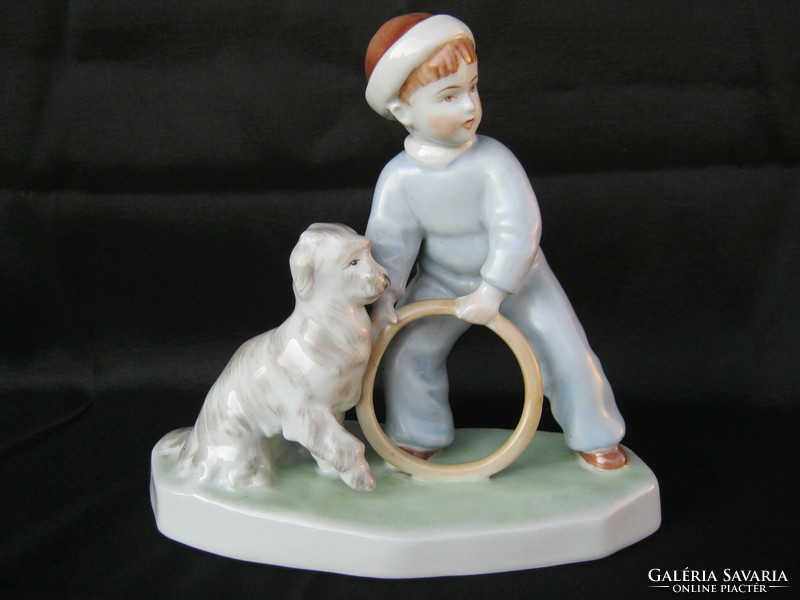 Zsolnay is a little boy playing with a porcelain dog